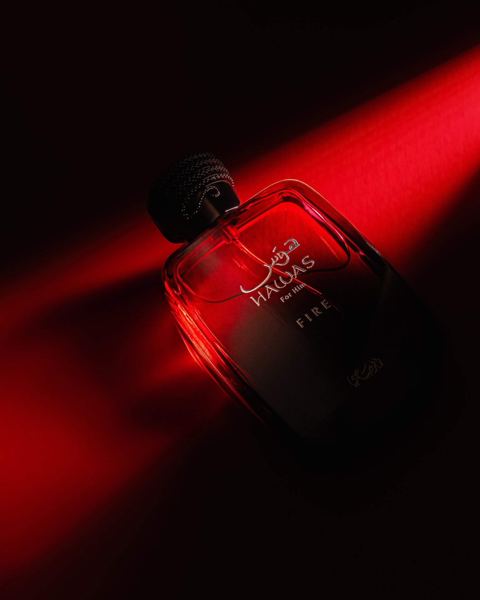 Hawas Fire bottle lit by a single red beam